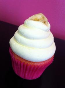 Strawberry cupcake with banana buttercream, topped with a banana chip.